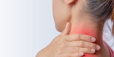 woman pain at trapezius muscle and holding right hand on muscle, swelling and inflammation of left rotator cuff muscle
